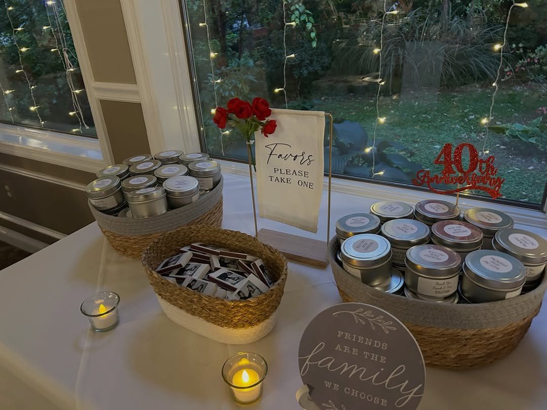 Silver metal candy tins and chocolates in woven baskets for a 40th anniversary party.