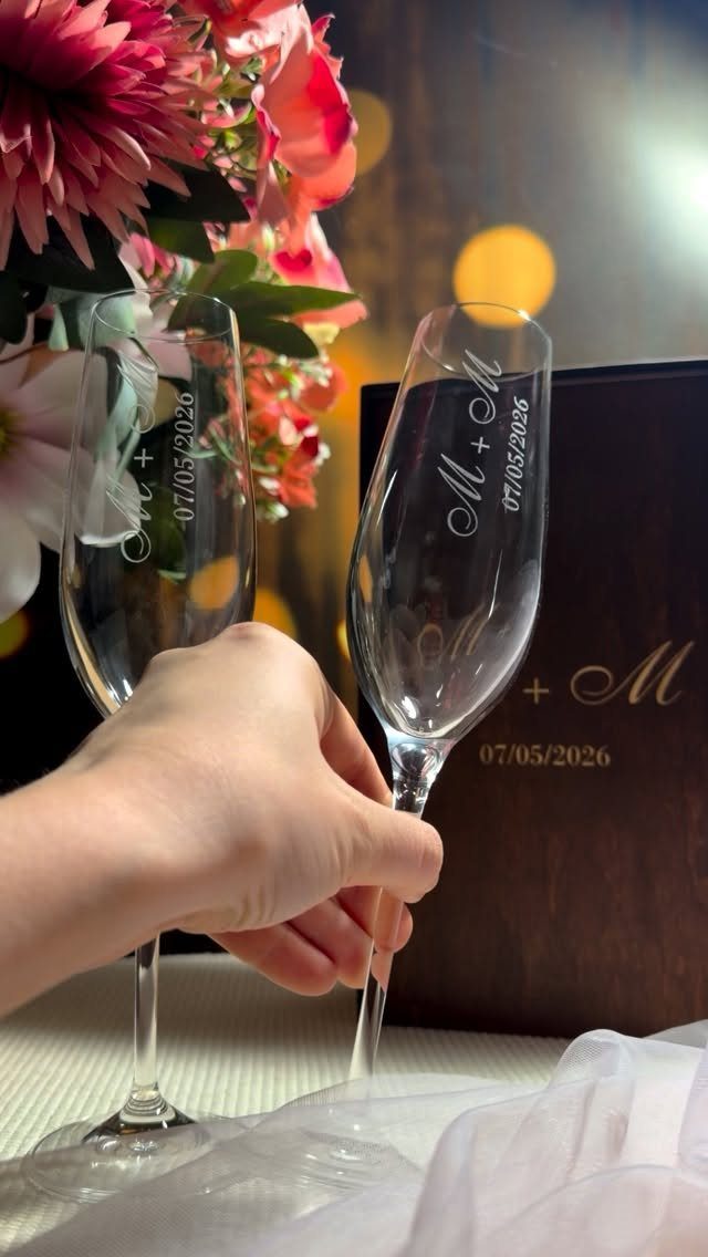 Two engraved champagne flutes and a matching wooden box with anniversary date.