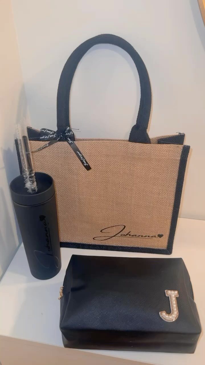 Personalized burlap beach bag with black handles, matching tumbler, and rhinestone makeup bag.