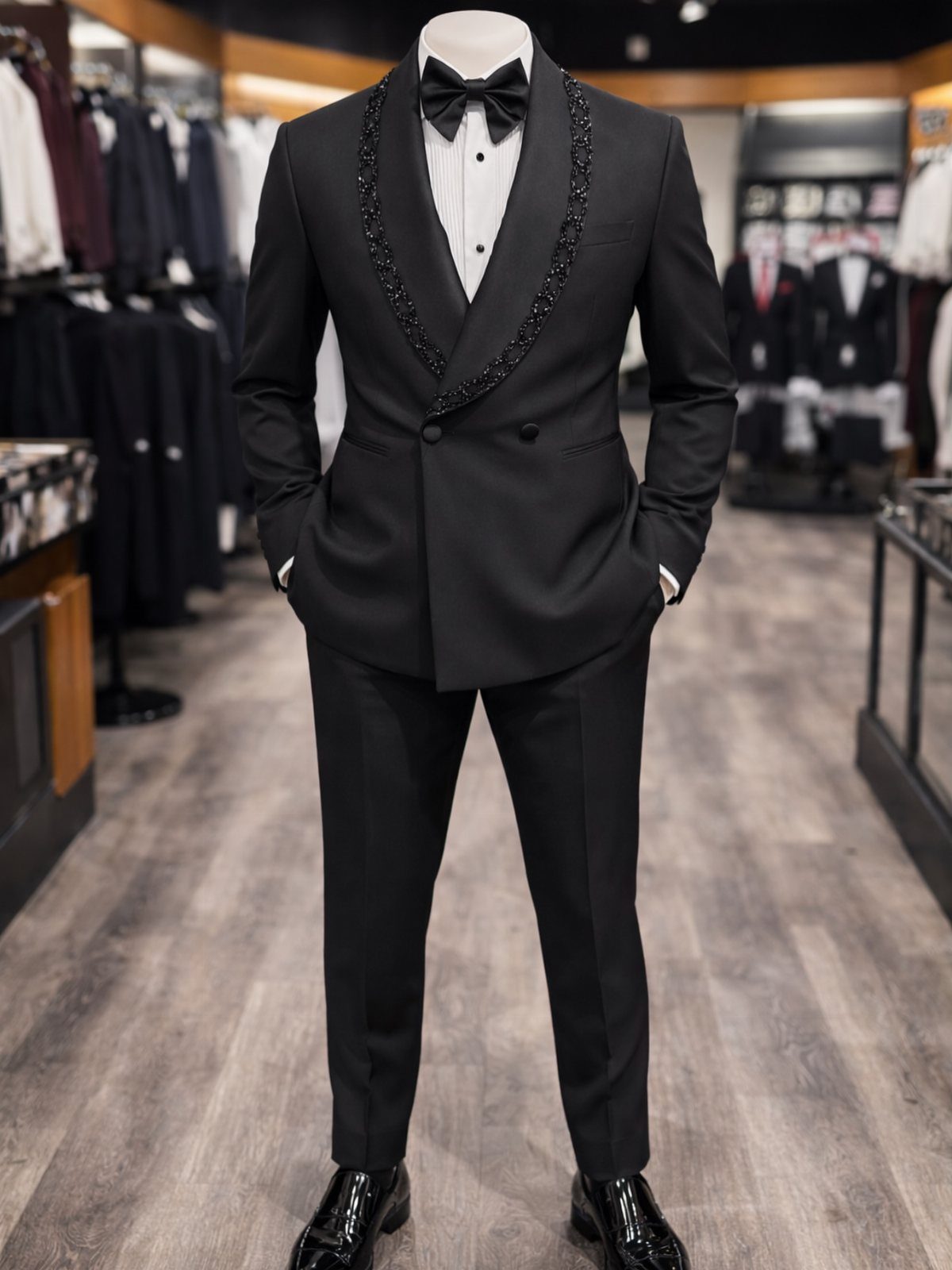 Black tuxedo with beaded lapels and bow tie displayed on a store mannequin.