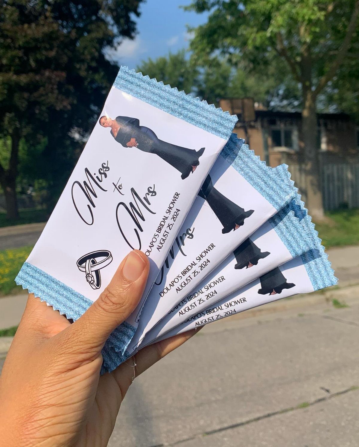 Custom wrapped chocolate bars for a bridal shower featuring a photo and ring.