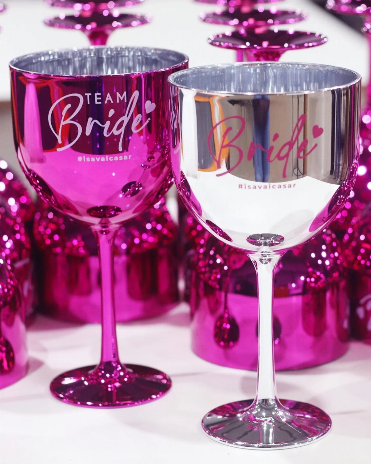 Pink and silver metallic wine glasses with Bride and Team Bride text.
