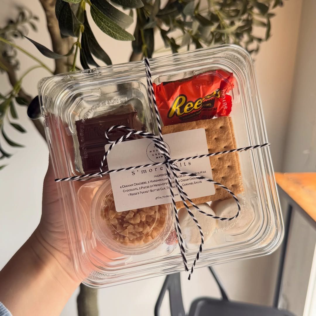 S'mores kit in a clear plastic container with ribbon and a label.