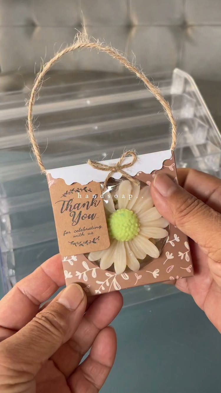 Daisy-shaped handmade soap in a small floral gift box with a thank you tag