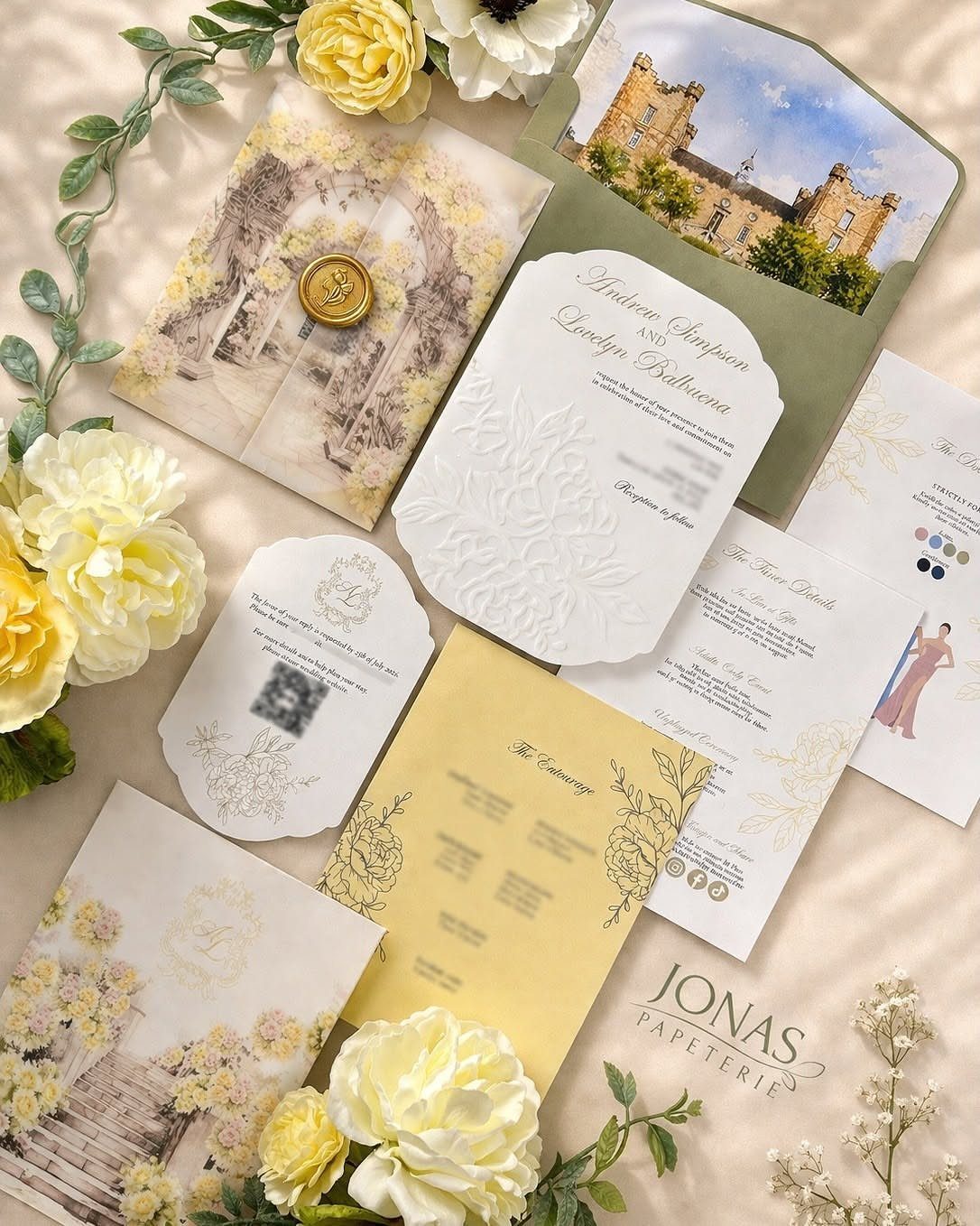 Wedding stationery set with butter yellow menus and white invitations surrounded by yellow roses.