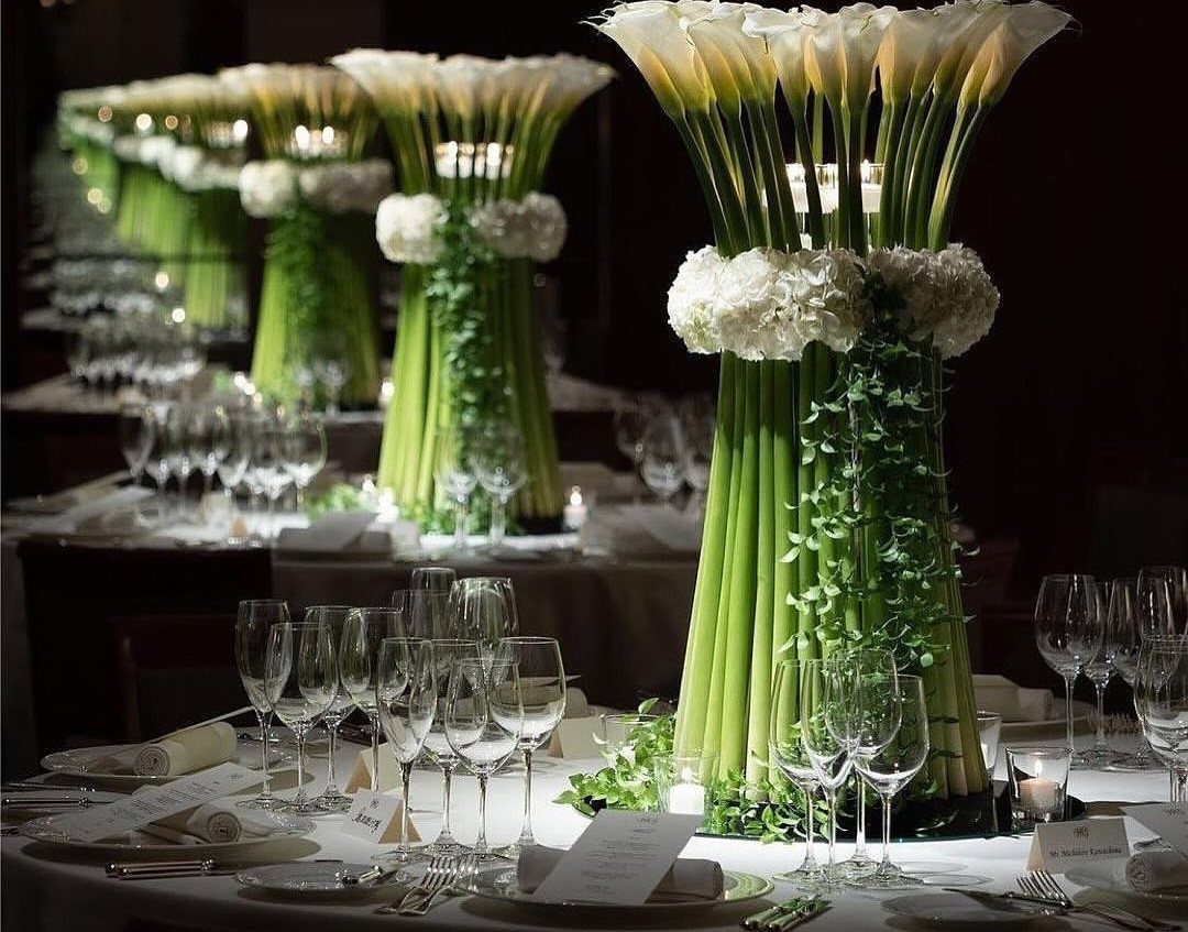 White calla lily and hydrangea centerpieces on a formal wedding dinner table