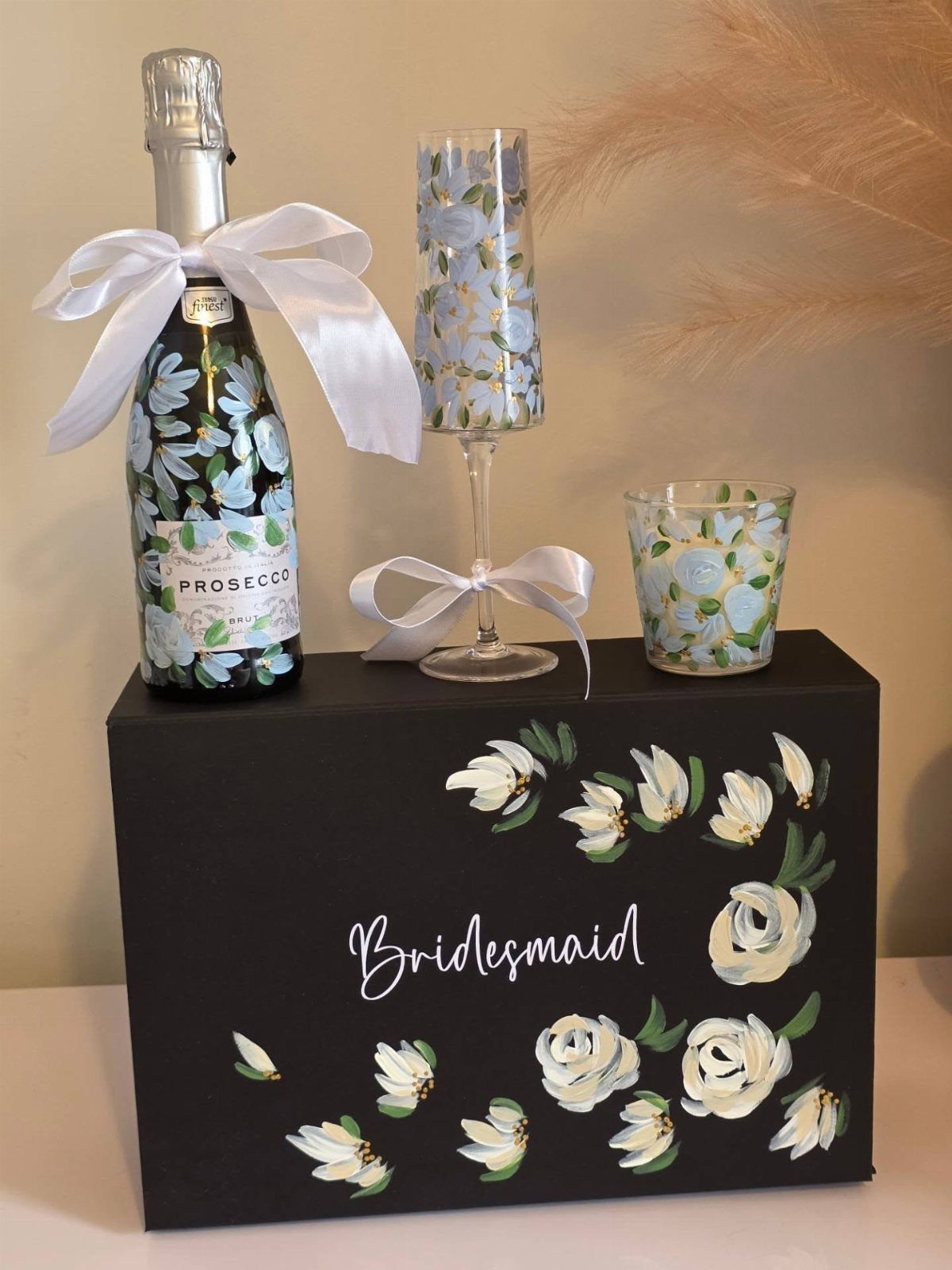 Bridesmaid gift box with Prosecco, champagne flute, and a floral scented candle.
