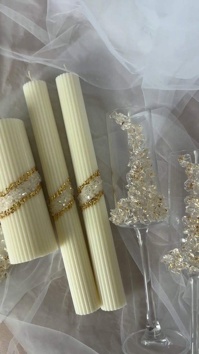 White ribbed pillar candles with gold crystal bands and embellished champagne flutes