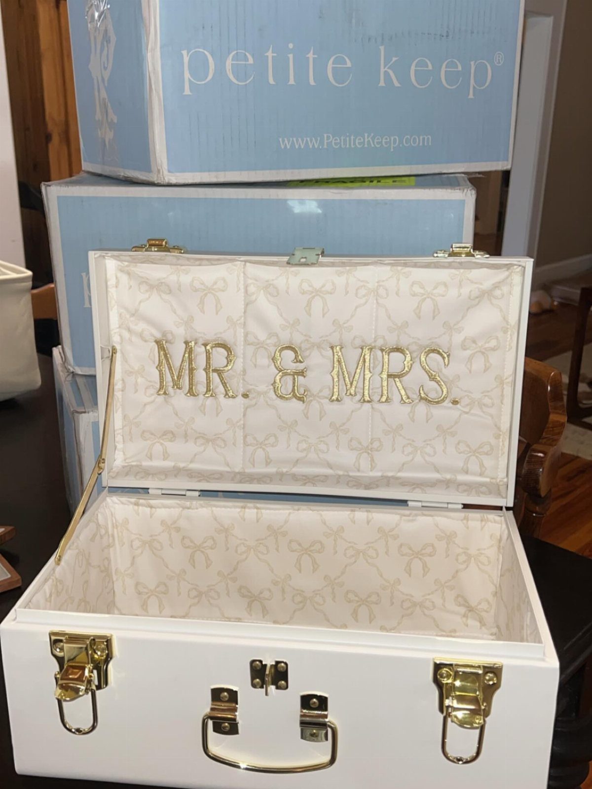 White keepsake box with gold hardware and MR. & MRS. embroidery on the lining