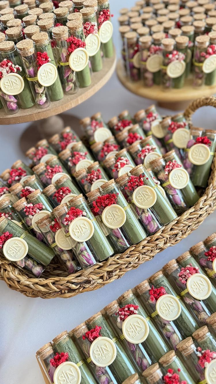 Glass test tubes filled with green tea and petals in a woven basket