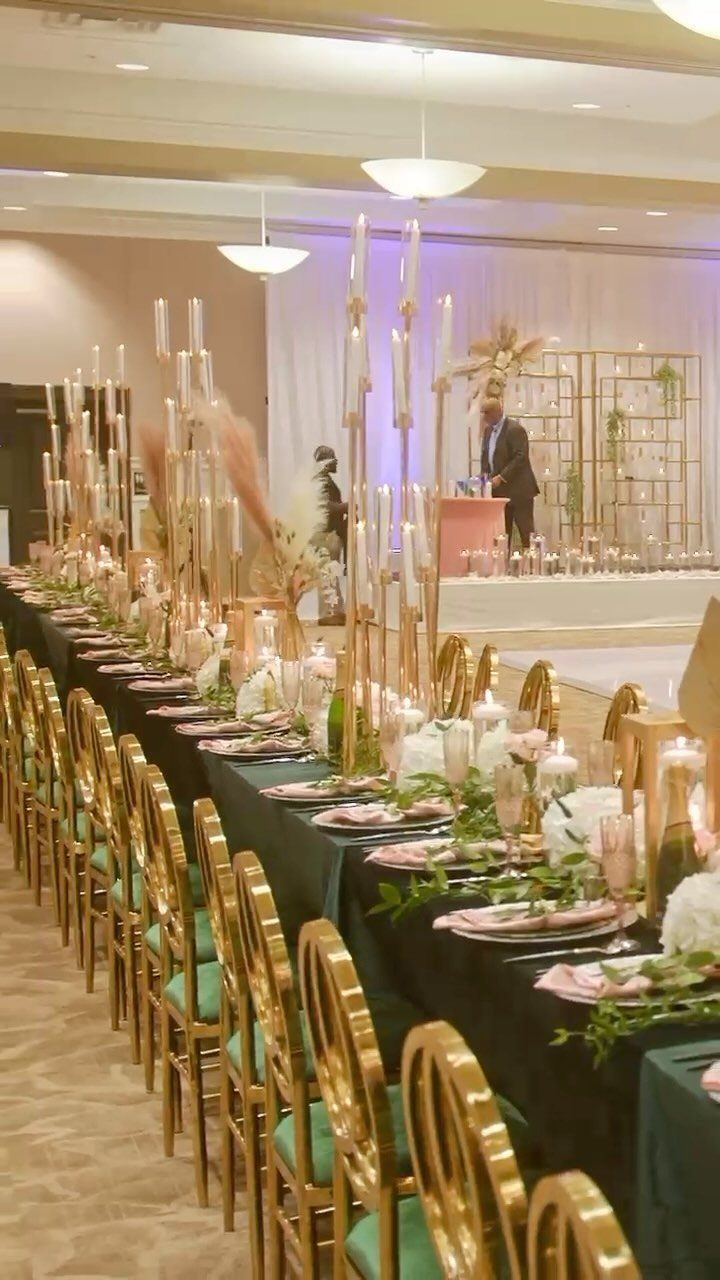 Emerald green banquet table with gold chairs and blush pink floral centerpieces