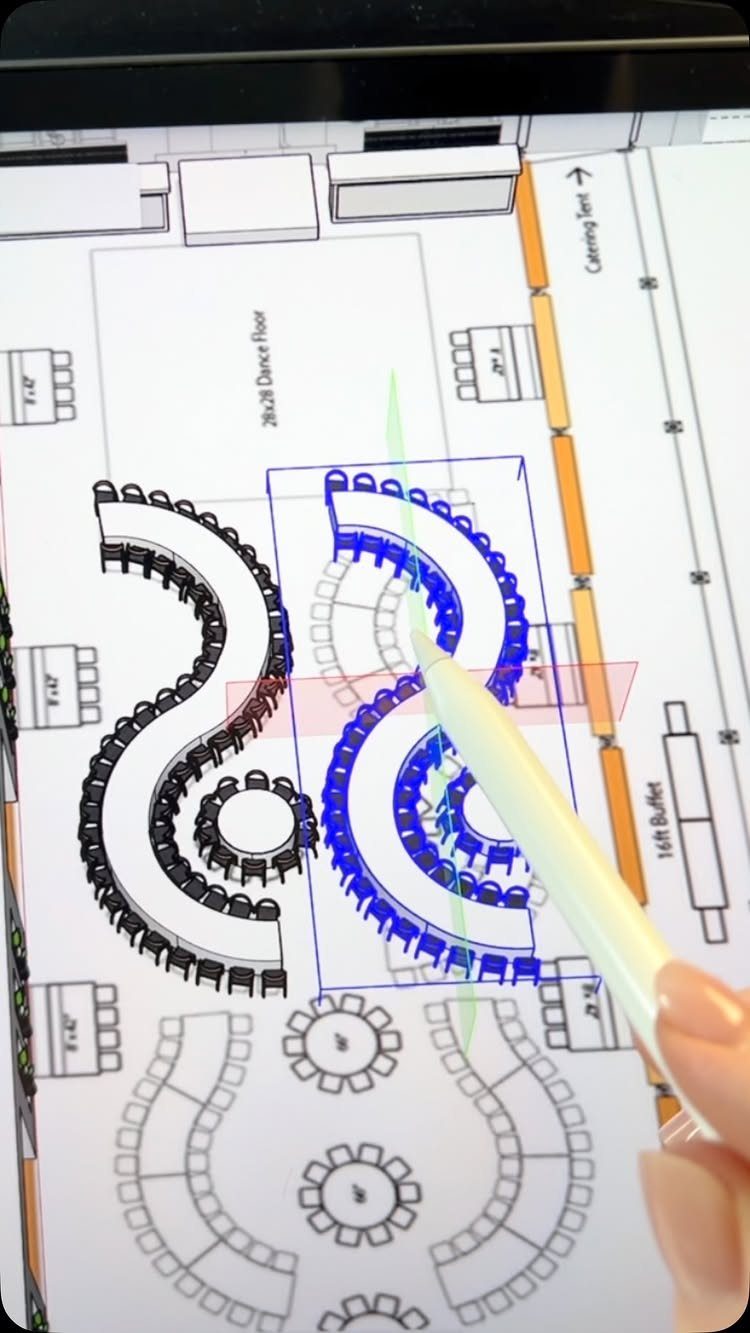 Digital wedding floor plan on a tablet being edited with a white stylus.