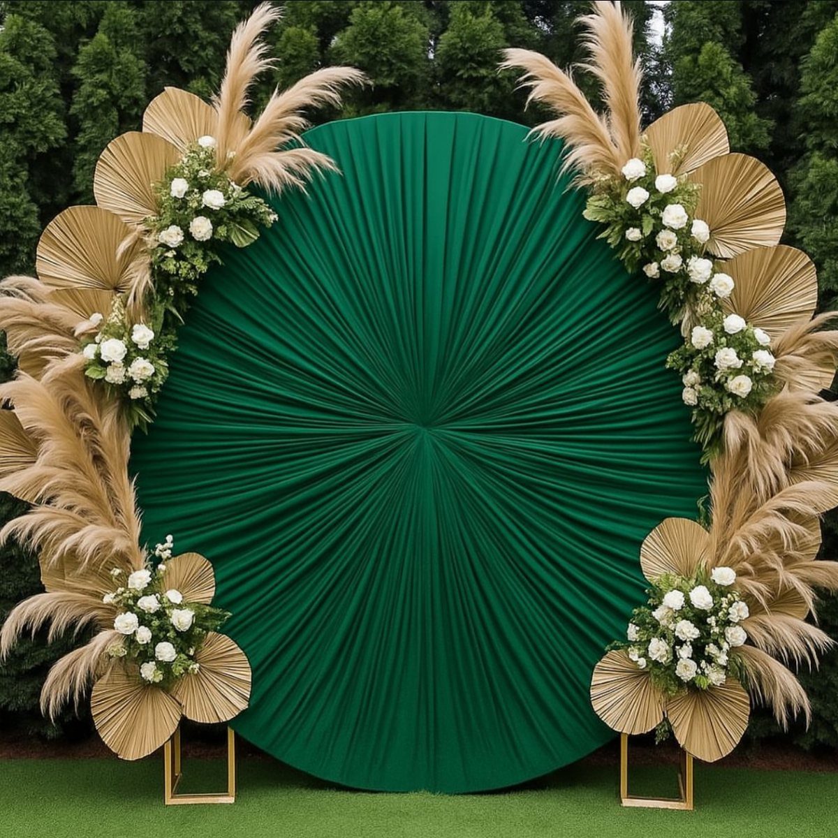 Circular green pleated backdrop adorned with white roses and dried pampas grass.