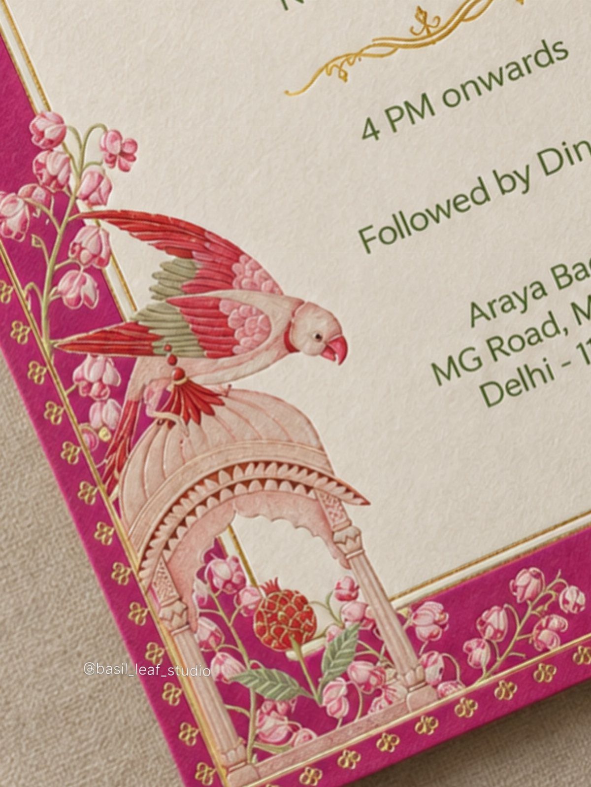 Invitation card with magenta borders, pink floral illustrations, and a red bird.