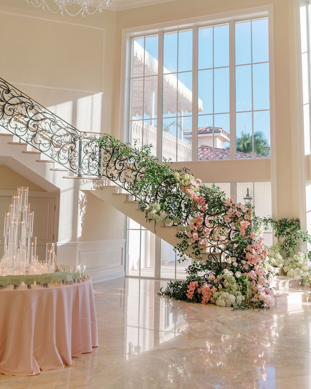 Floral wedding decor with pink and white flowers on a grand staircase railing
