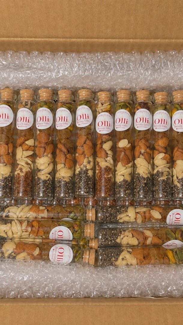 Glass test tubes filled with layered trail mix and cork stoppers in packaging
