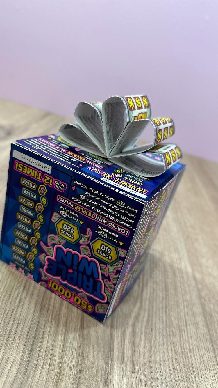 Lottery ticket box with tickets folded into a flower on top