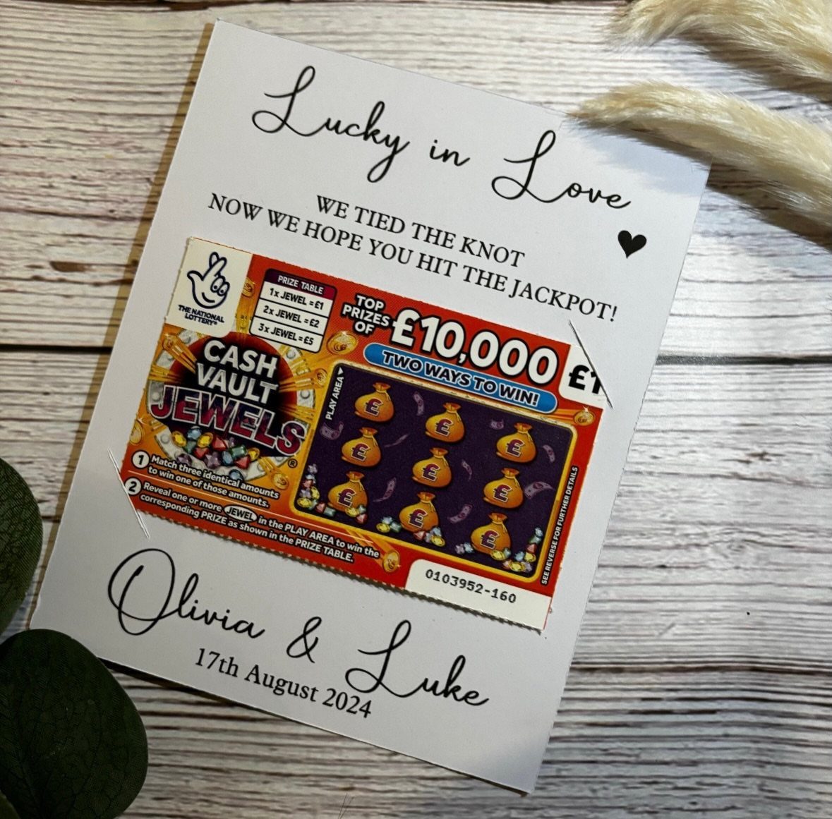 Lottery ticket attached to a white wedding favor card for Olivia and Luke.