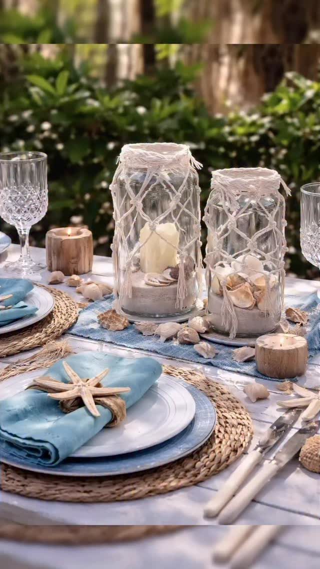 Mason jars with macrame netting and sand on a beach themed table setting
