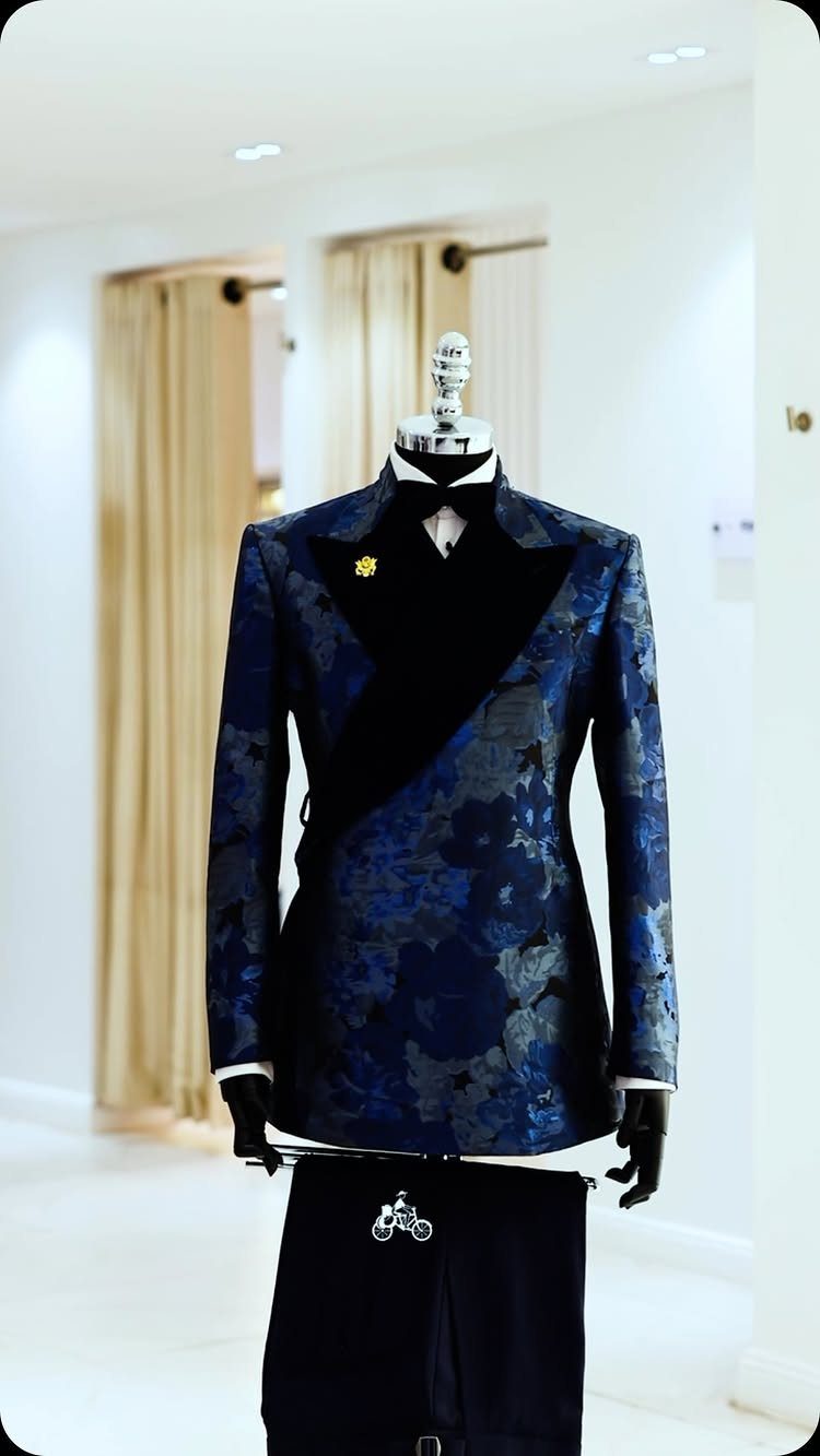 Navy blue floral patterned tuxedo jacket with black lapels on a mannequin torso.