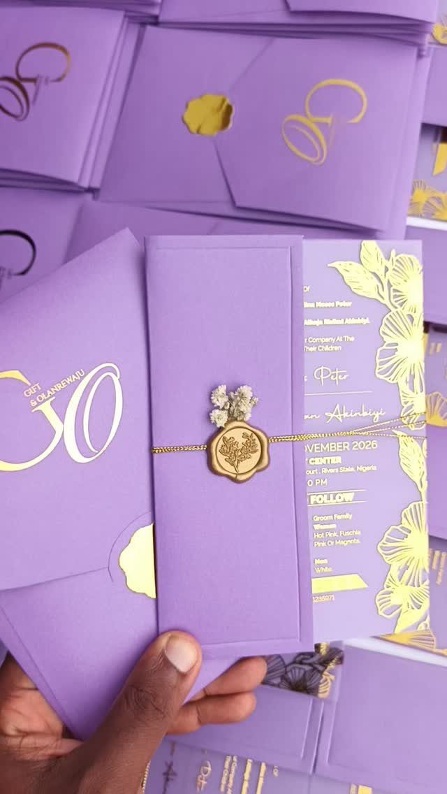 Purple wedding invitation set with gold foil lettering and a gold wax seal.