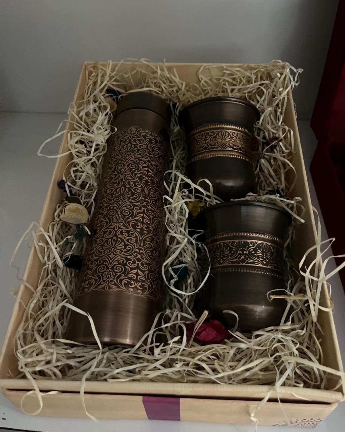 Copper water bottle and two tumblers with engravings in a wooden gift box