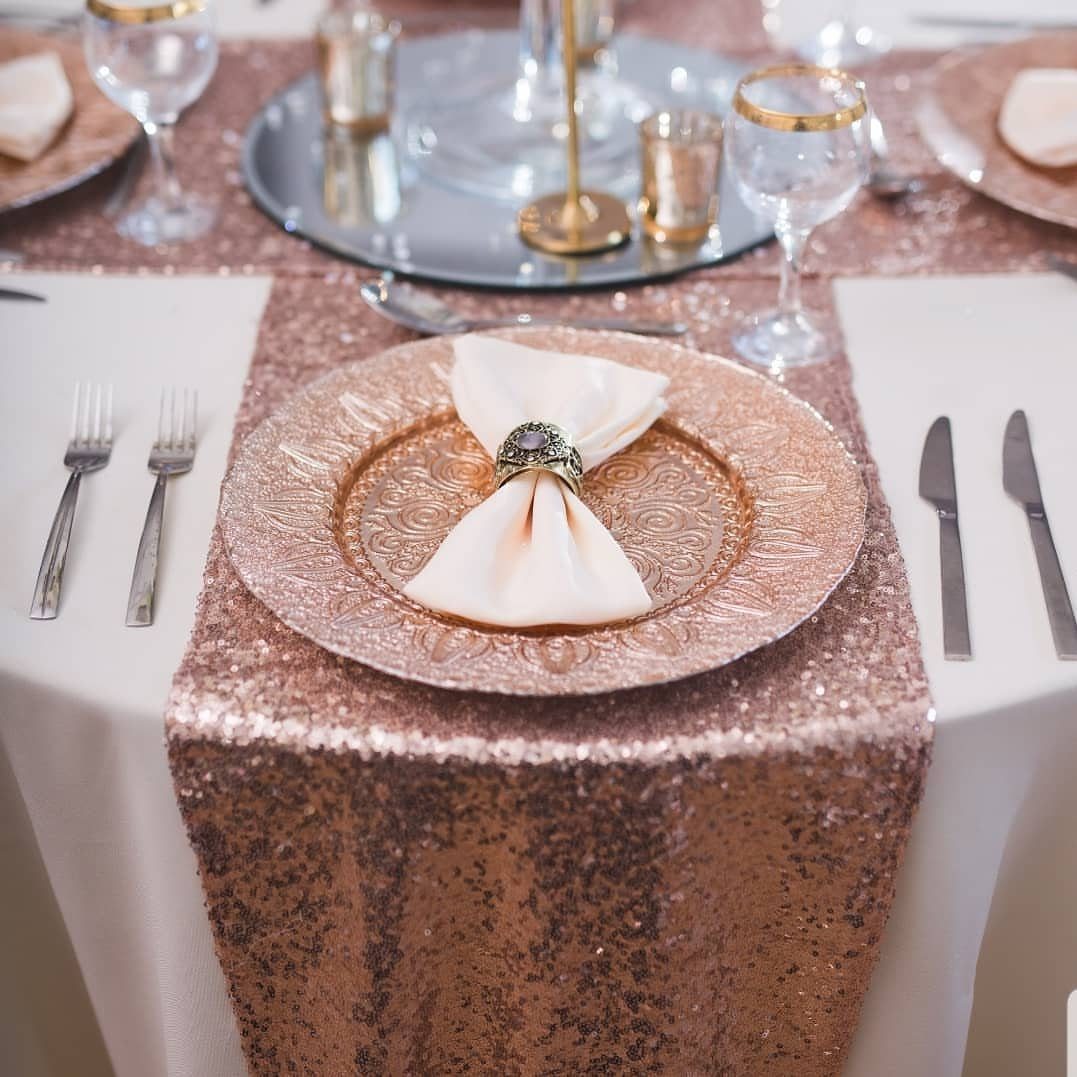 Rose gold sequined table runner with matching charger plate and elegant wedding tableware.