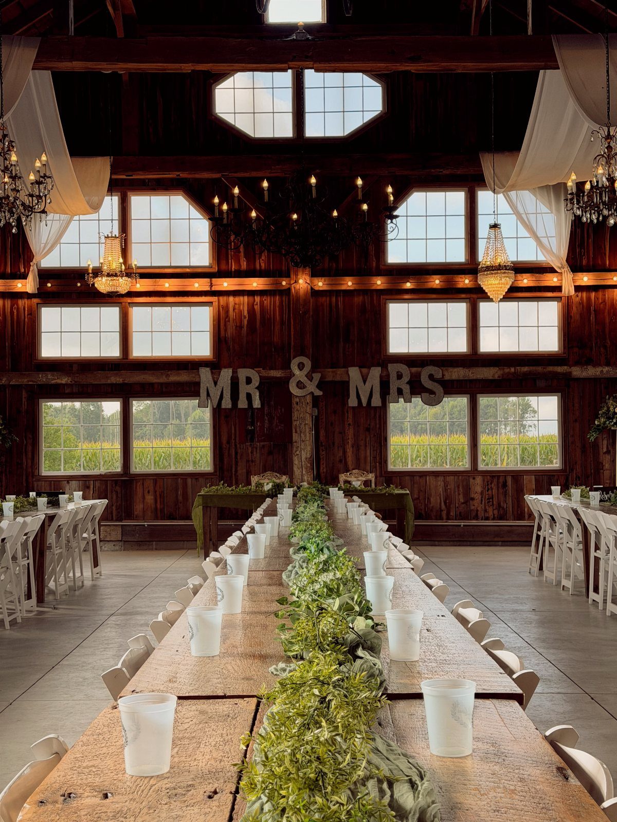 Large MR & MRS letters on a wooden wall behind a long wedding table.