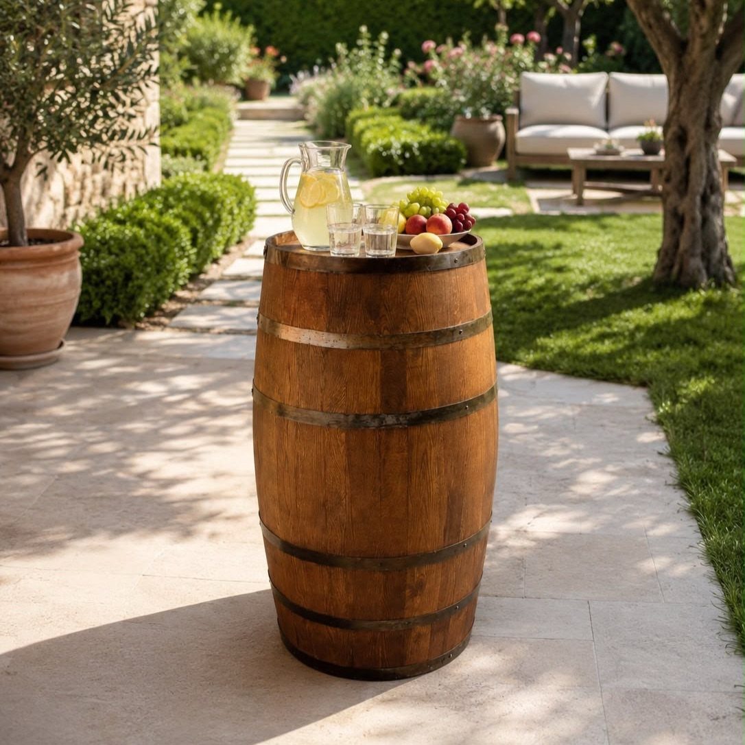 Wooden wine barrel table with lemonade and fruit on a sunny stone patio