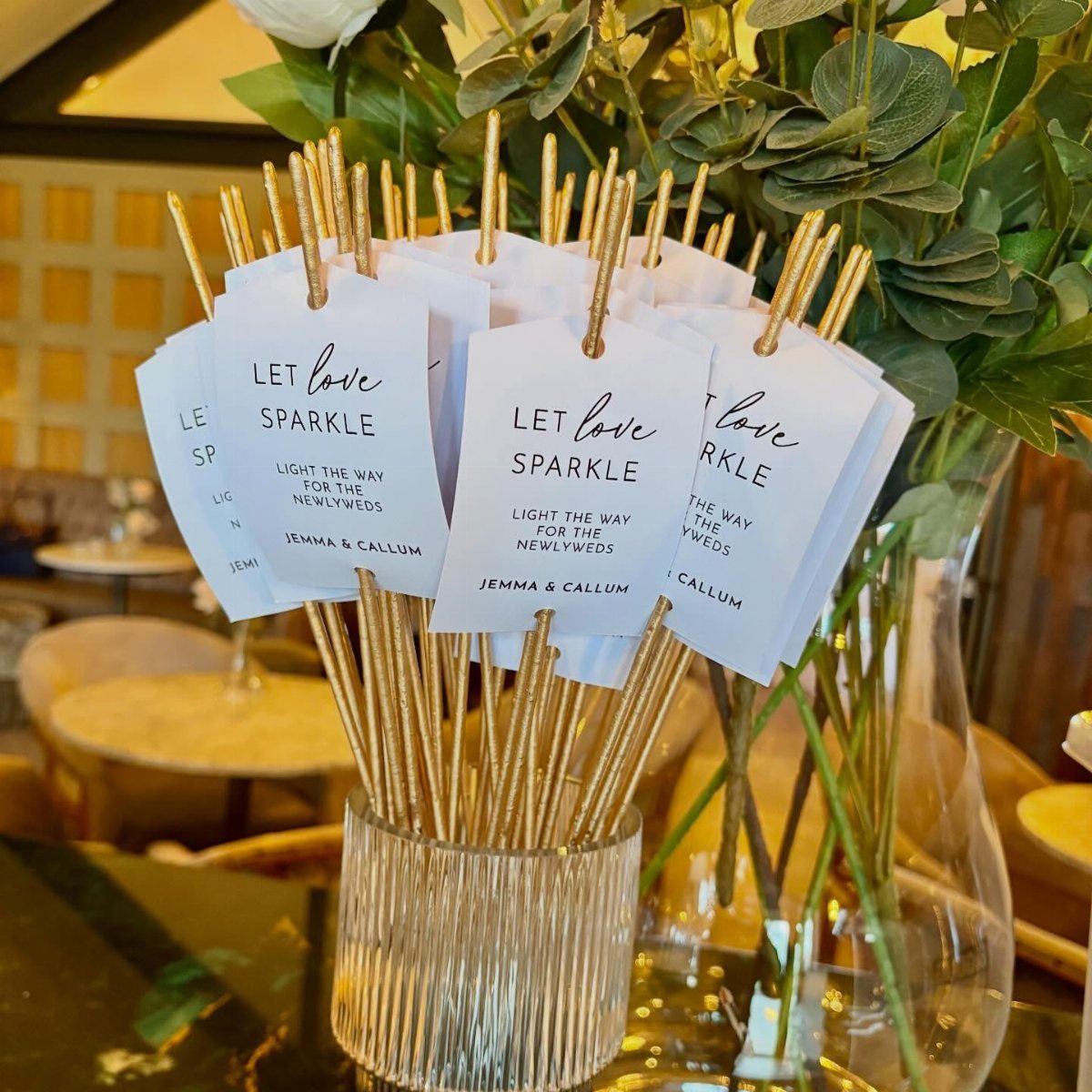 Gold sparklers in a glass vase with Let Love Sparkle tags