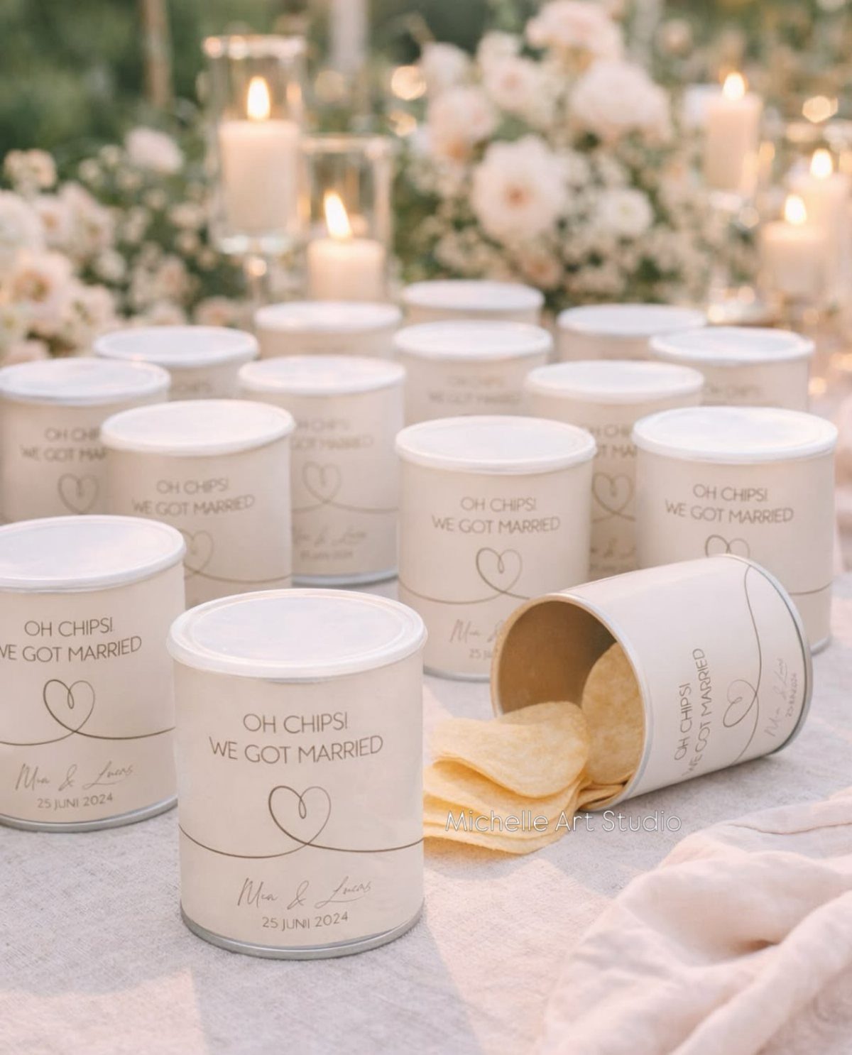 White cylindrical chip containers with wedding text spilling potato chips on a table