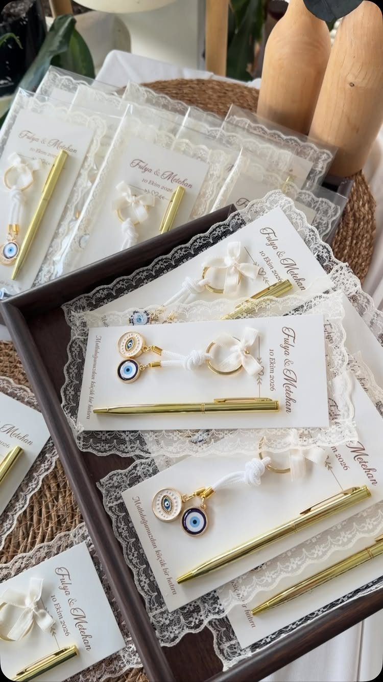 Gift sets with gold pens and evil eye charms on white cards