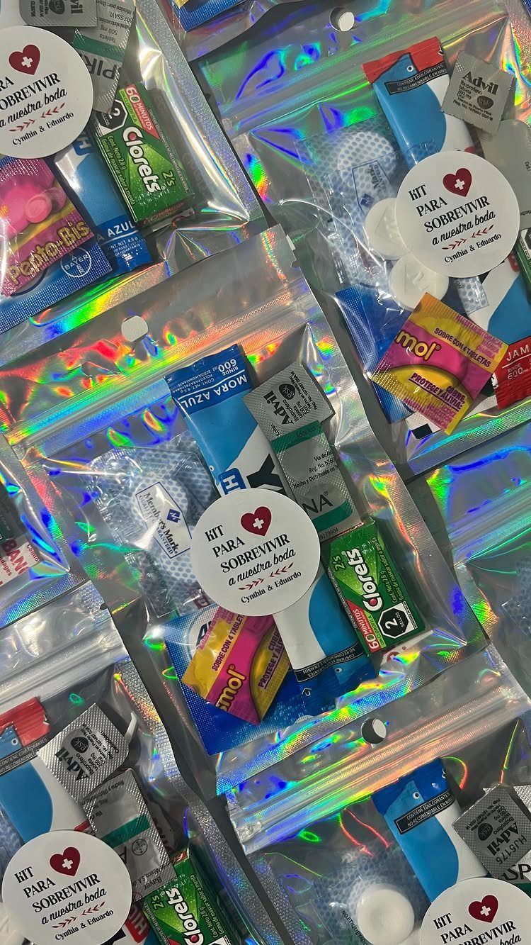 Holographic zip-lock bags filled with mints and candies as wedding favor kits.