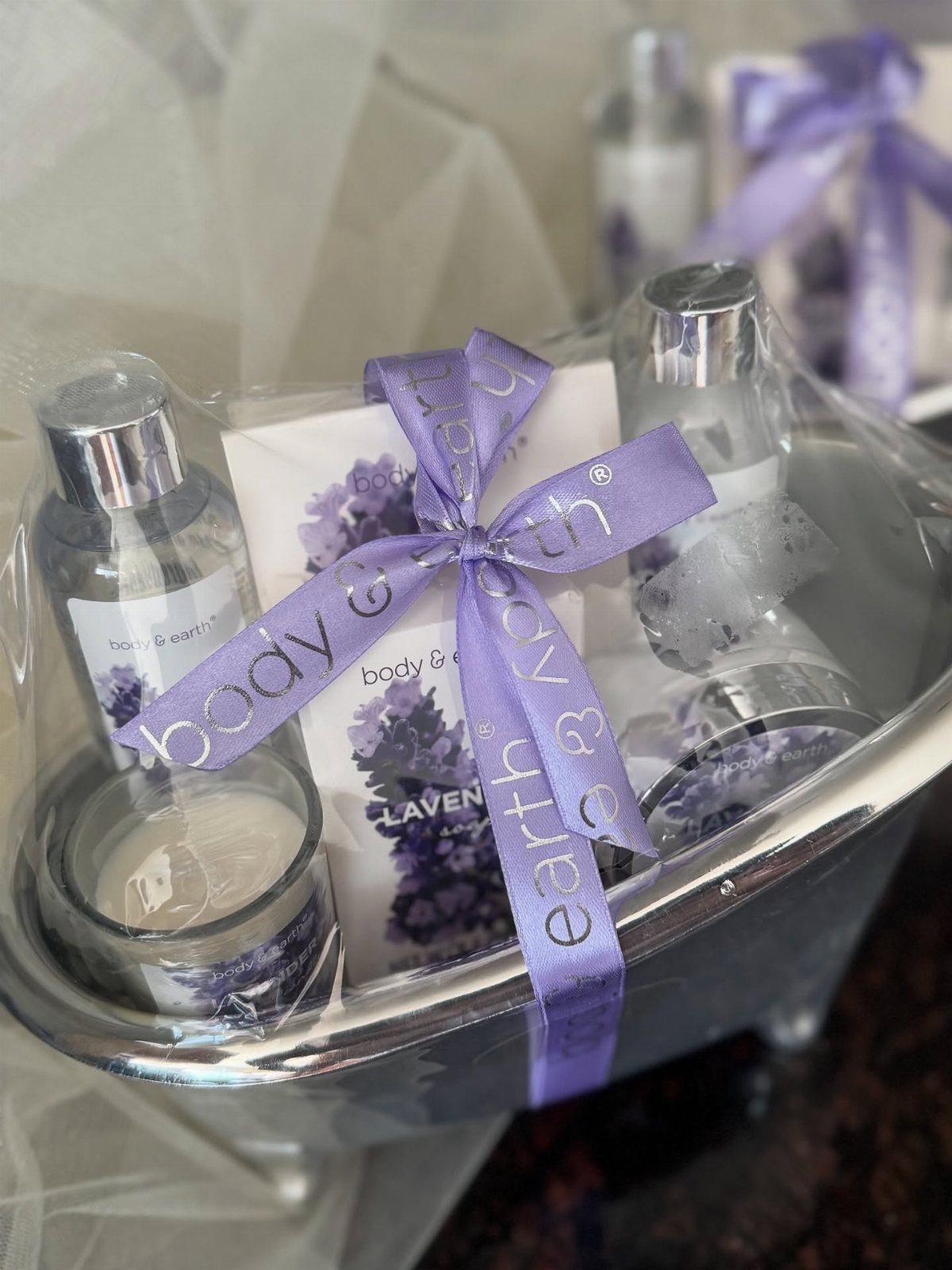 Mini spa kit in a silver tub with lavender products and purple ribbon.