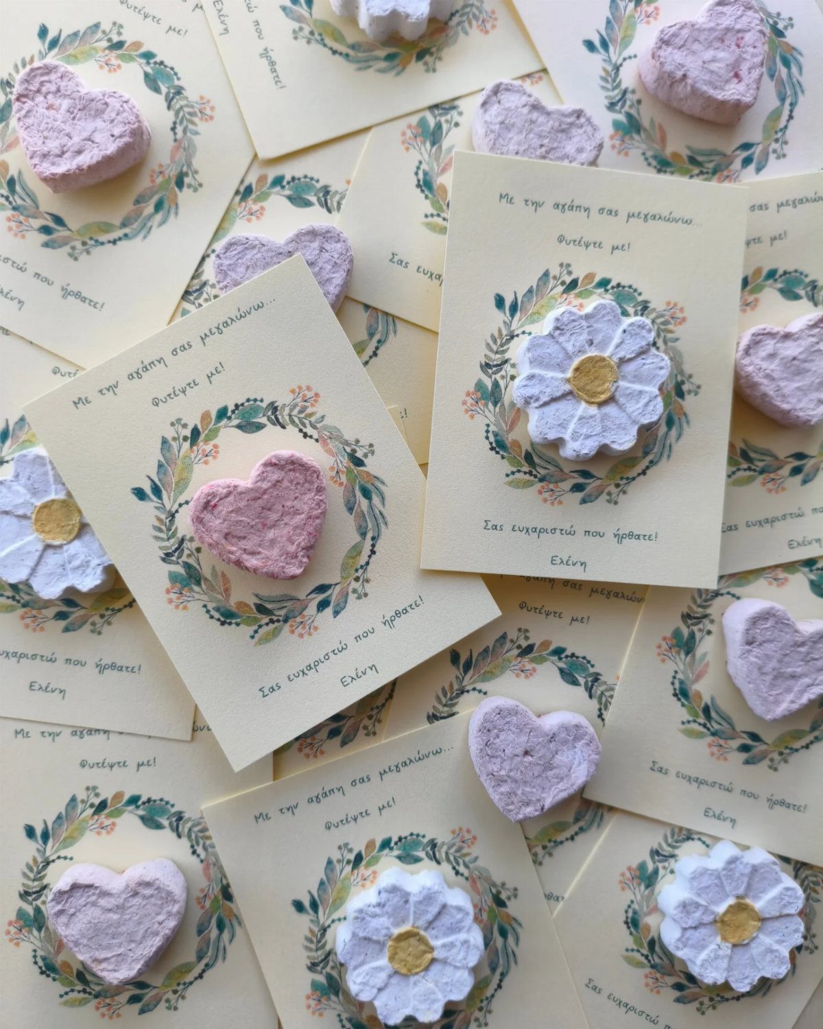 Heart and flower shaped seed bombs on floral greeting cards for bridal favors.