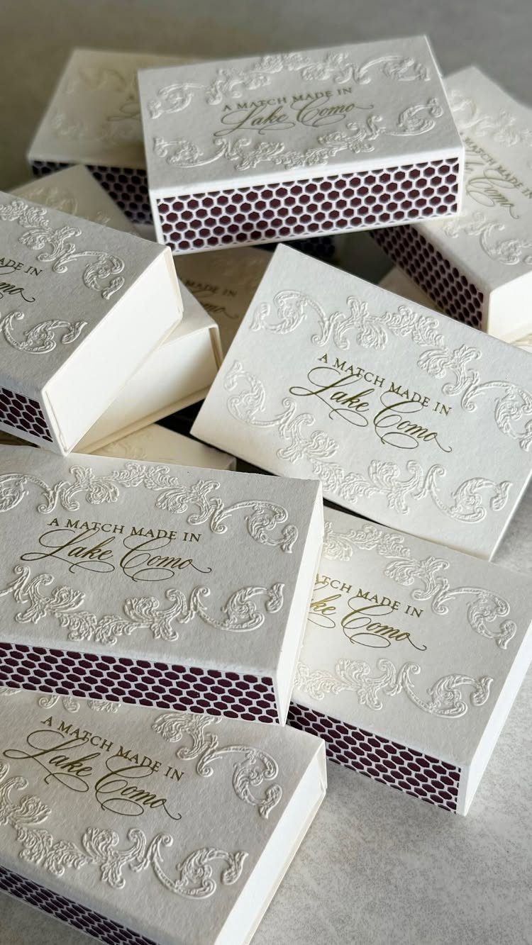Custom white matchboxes with embossed floral designs and purple polka dot sides.