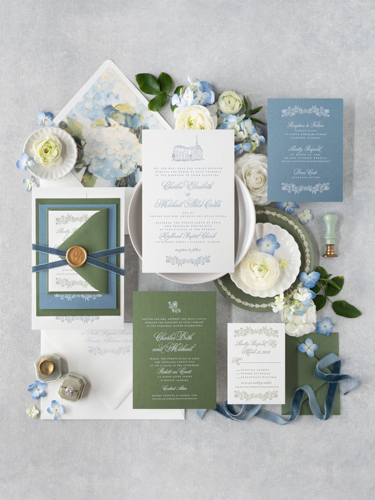 Wedding invitation suite in sage green and navy blue with floral accents