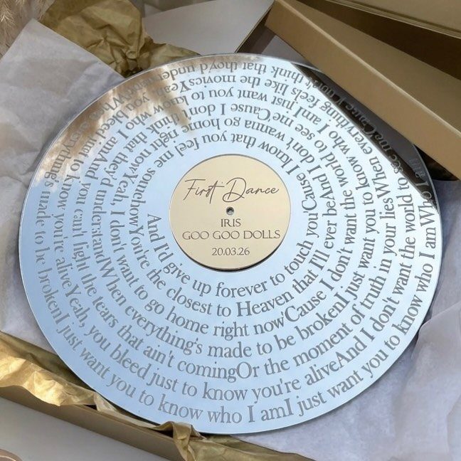 Silver engraved vinyl record in a gold gift box for a first dance.