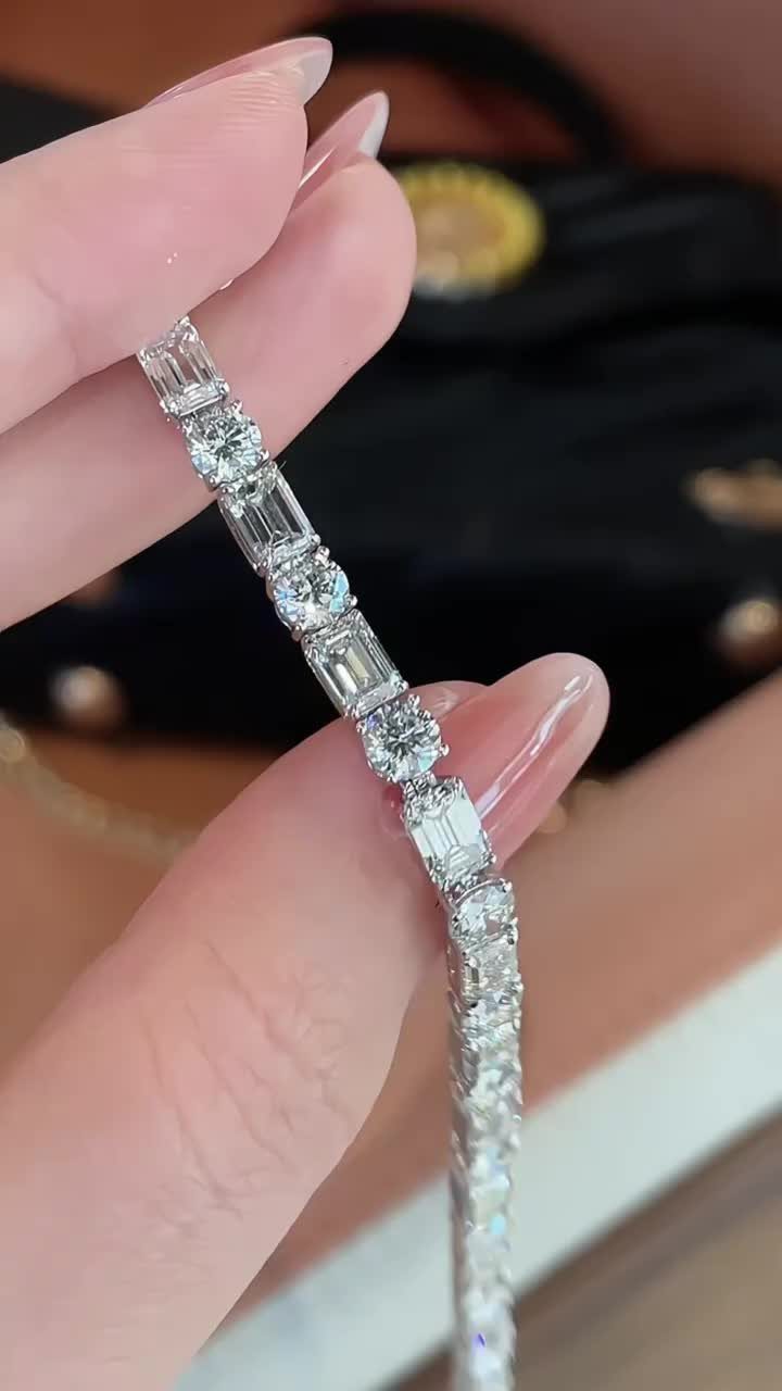 Diamond tennis bracelet with alternating round and baguette cuts held by fingers