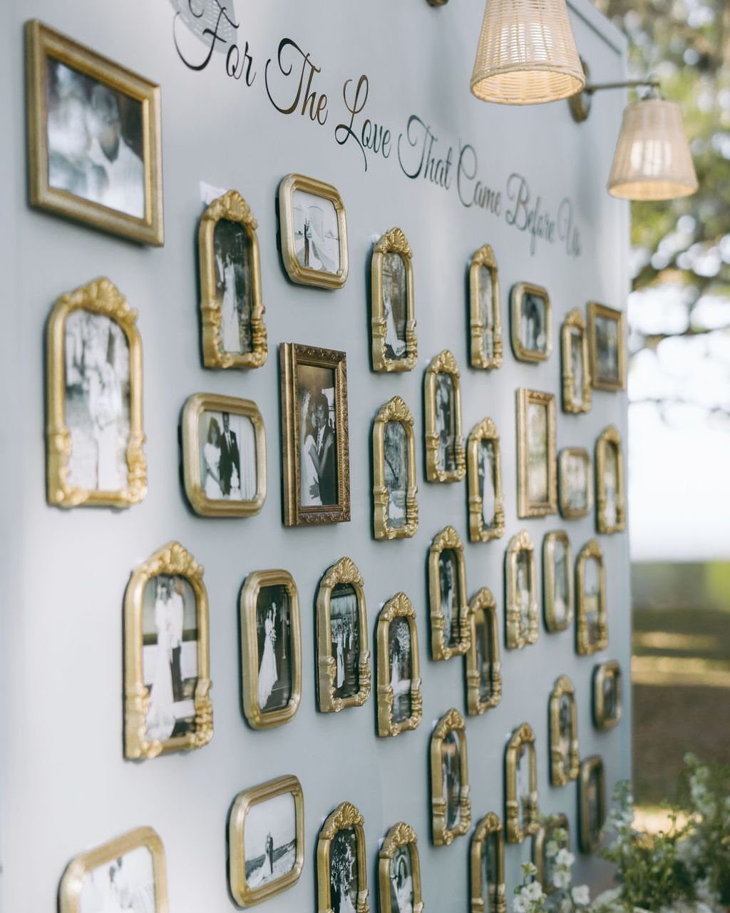 Gold ornate picture frames with black and white photos on a white wall.