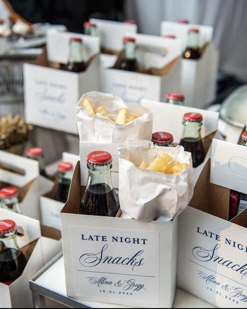 Late night snack packages with soda and fries in personalized white boxes.