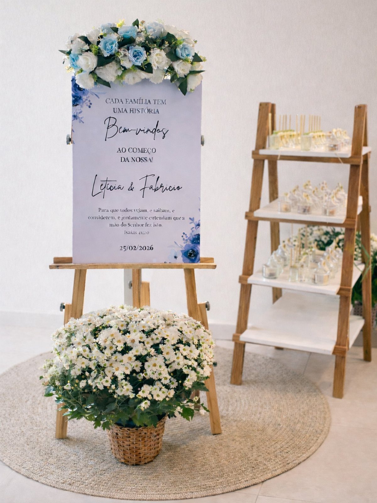 Wedding welcome sign on easel next to a wooden shelf with favor boxes.