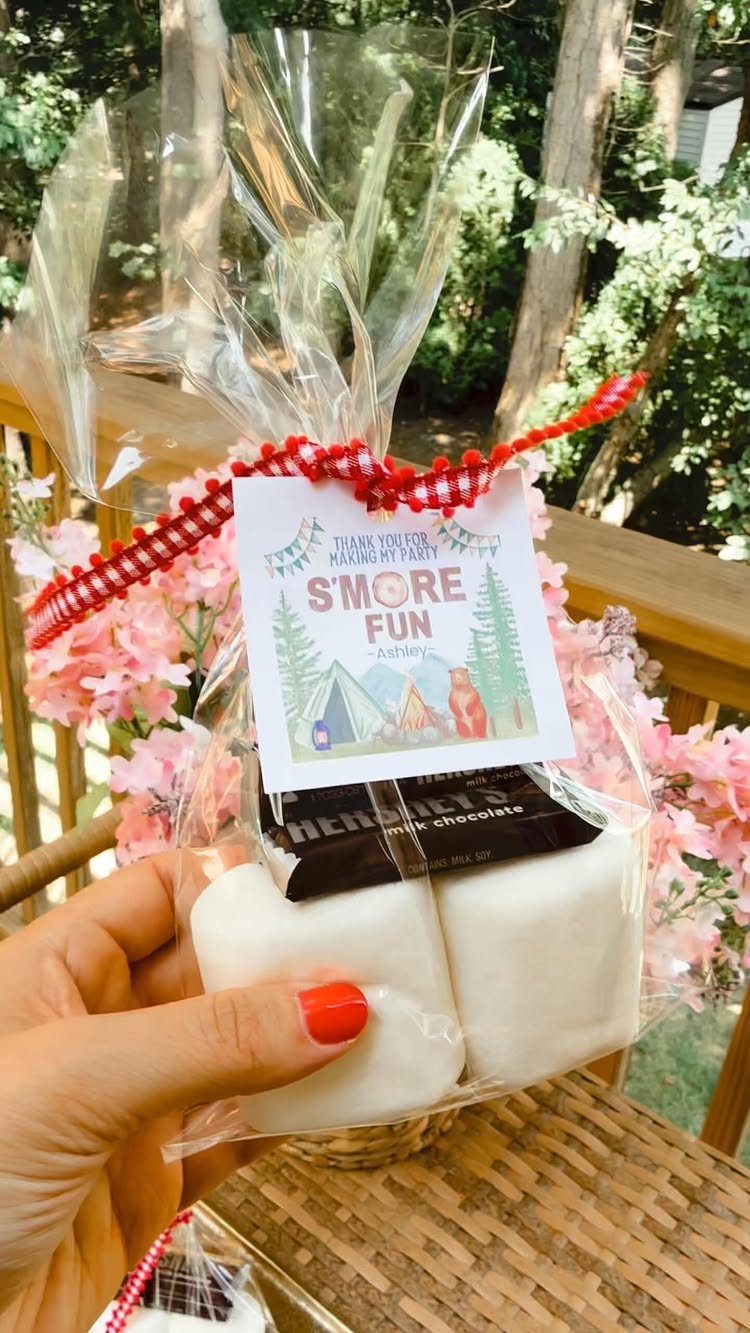 S'mores kit in a clear bag with marshmallows, chocolate, and a camping tag.
