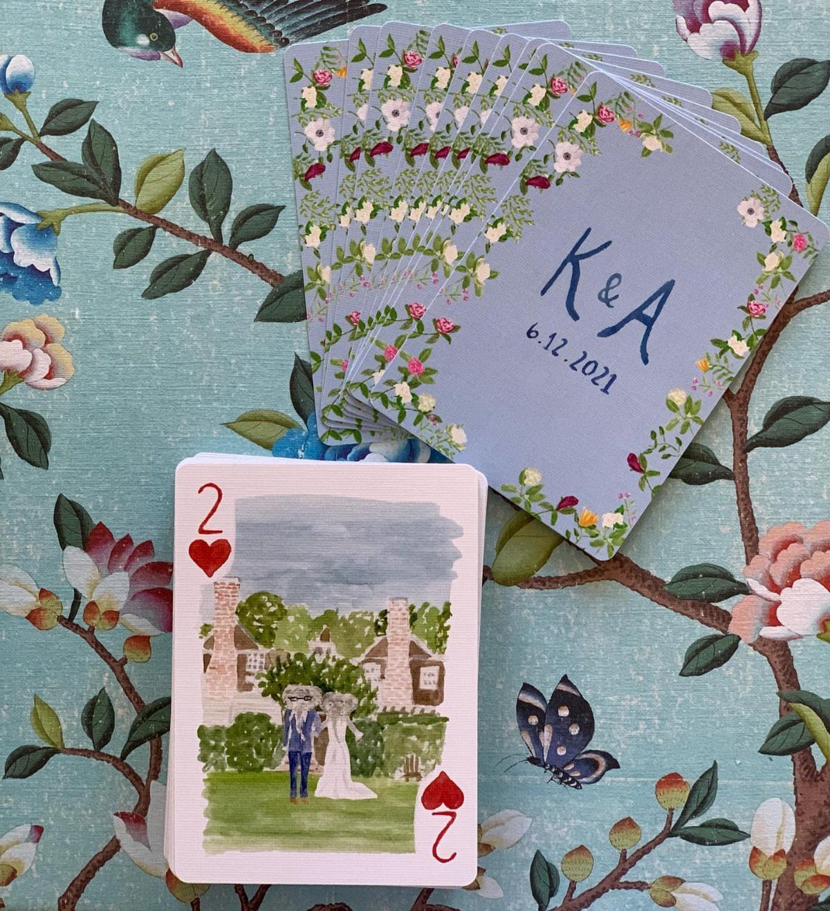 Custom playing cards with floral designs and a watercolor wedding couple illustration.