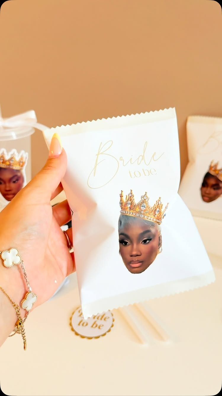 White snack bag with bride's photo and crown held by a hand.