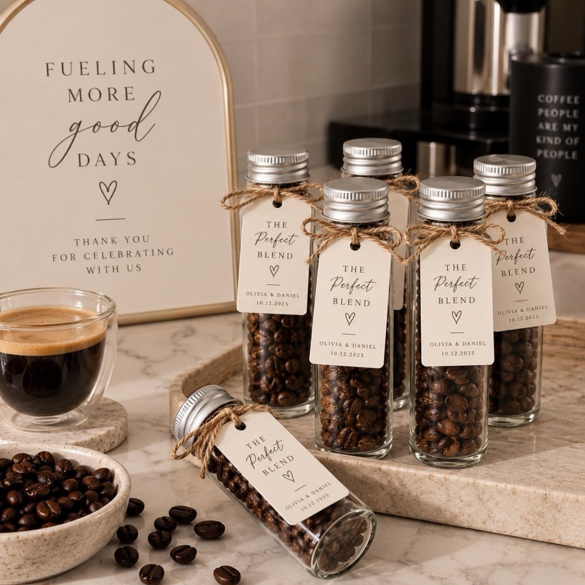 Small glass jars of coffee beans with wedding tags on a marble surface.