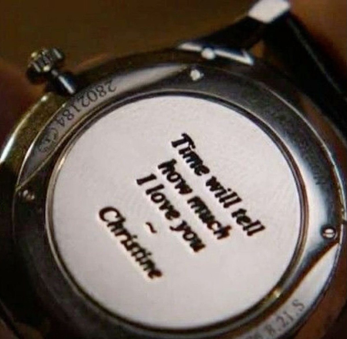 Silver wristwatch back with an engraved romantic message signed by Christine