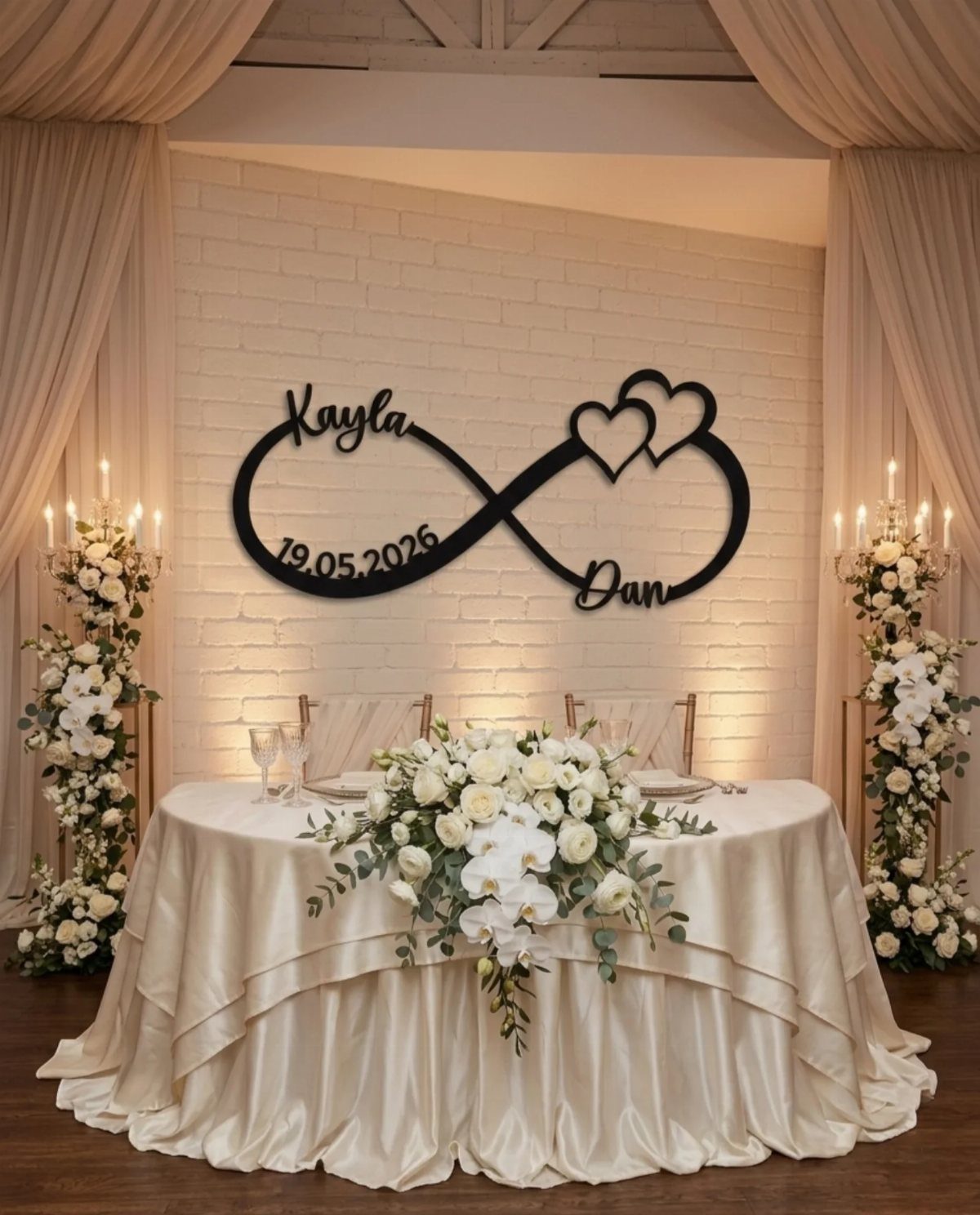 Infinity symbol wedding sign with names and date on a white brick wall