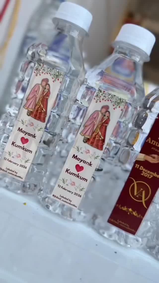 Custom water bottles with personalized labels featuring a couple's illustration and names.