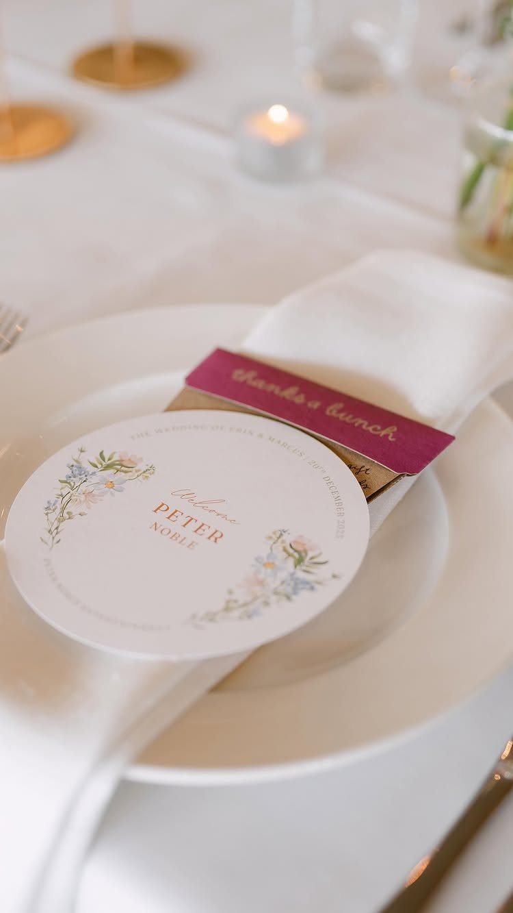 Seed packet with magenta band on a wedding plate with name card
